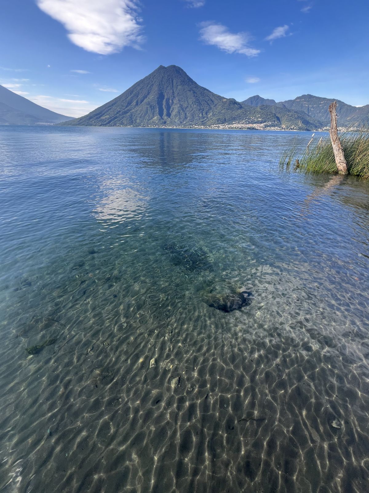 Clear waters of Lake Atitlán with volcano backdrop