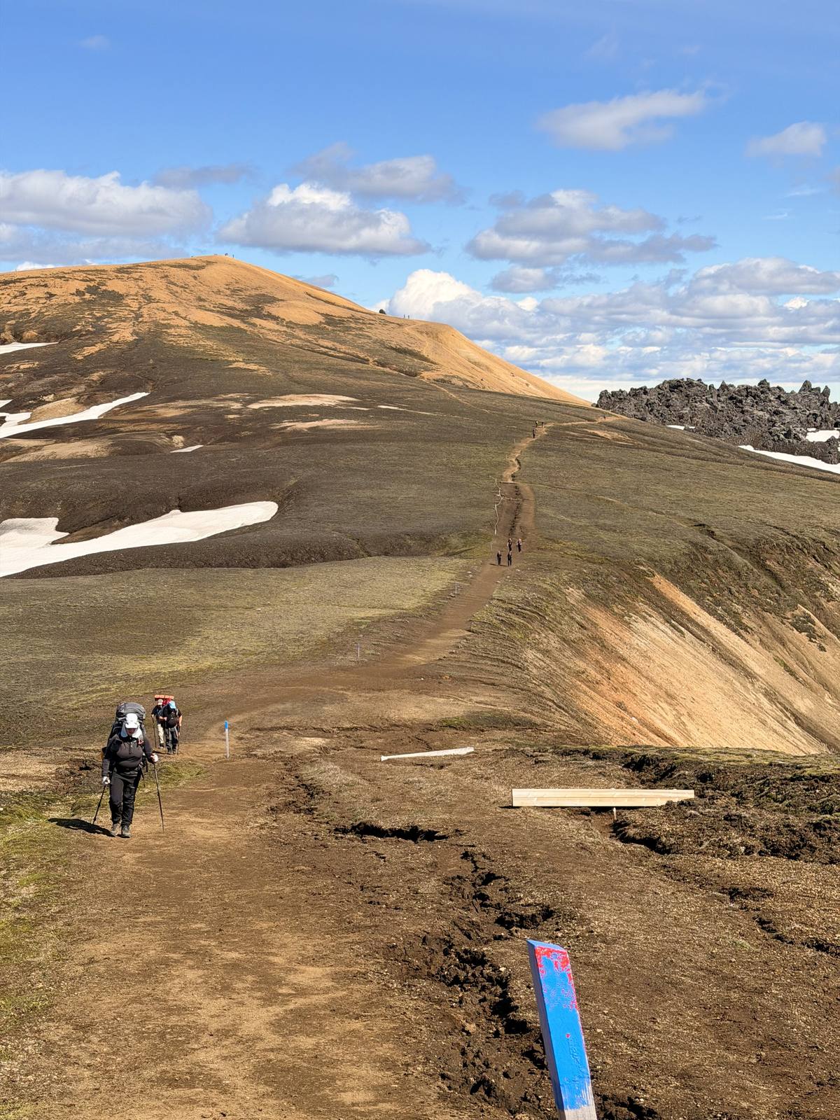 Hikers on a ridgeline trail through the Icelandic highlands